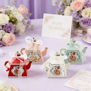 Elegant teapot shaped party favor boxes in pastel colors with floral prints and ribbons
