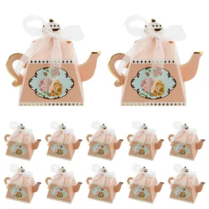 Set of 12 teapot-shaped pink paper candy boxes with floral patterns and ribbons.
