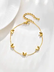 Détail de la chaîne en acier inoxydable doré avec des pendentifs papillon chic