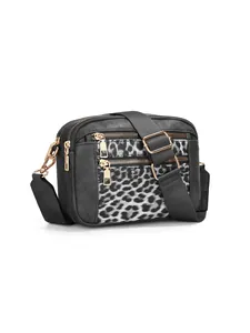 Detailed view of leopard print crossbody bag featuring multiple zippers and strap