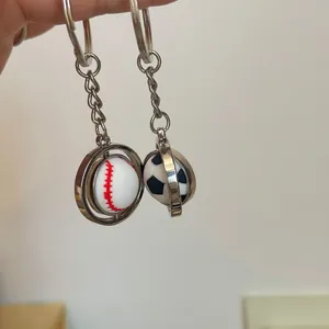 Close-up of rotatable spinning metal keychain with baseball and football designs