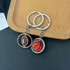 Rotating metal sports keychain set featuring a mini 3D basketball and American football