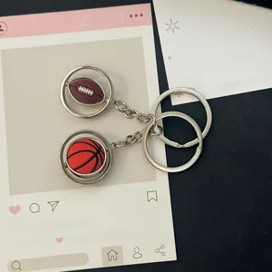 Detail showing rotating metal basketball and rugby pendants on high-quality keychains
