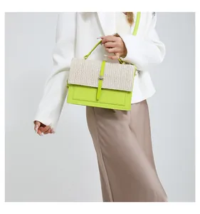 Close-up detail of lime green woven patchwork crossbody bag with straw texture flap