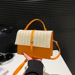 Orange candy-colored patchwork crossbody bag with straw woven flap and gold buckle