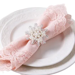 Elegant silver snowflake napkin ring adorned with pearls on a pink lace napkin