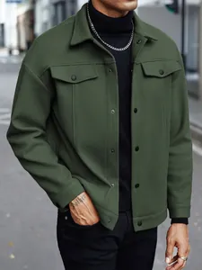 Detailed macro view of men olive green wool jacket featuring lapel collar and metal snap buttons