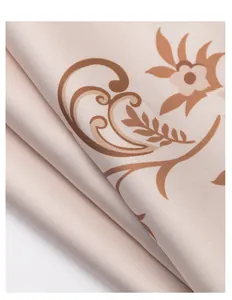 Close-up detail of soft satin fabric with elegant brown floral paisley print patterns