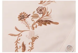 Macro view of elegant brown floral print on silky pink chiffon pajama fabric with button