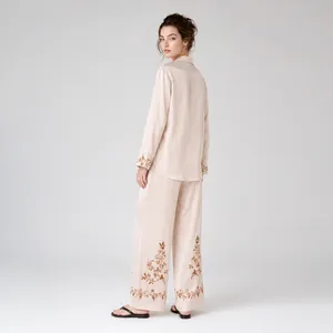 Elegant champagne satin pajama set with floral embroidery on long sleeves and pants