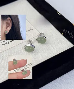 Close-up of minimalist grape green crystal stud earrings in S925 sterling silver