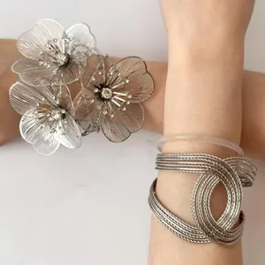 Statement metal flower open cuff bracelet with mesh wire knot jewelry shown on arm