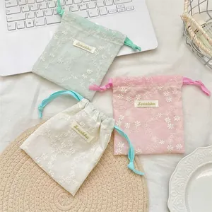Three-piece set of floral embroidered mesh drawstring pouches for cosmetics and travel