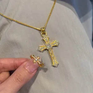Elegant gold-plated cross pendant necklace and matching ring set with shiny crystals