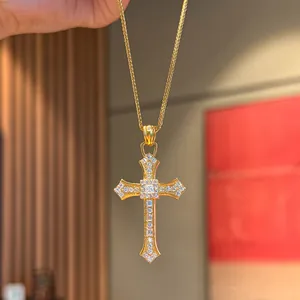 Exquisite gold-toned cross pendant necklace heavily inlaid with shimmering crystals