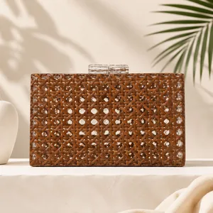 Close-up view of a retro brown woven rattan evening clutch bag with acrylic clasps