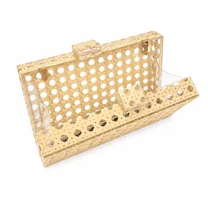 Detail view showing the open interior of a rattan woven clutch bag with acrylic panels