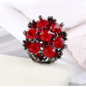 Elegant fashion cluster ring featuring large faceted red zircons in a gunmetal finish
