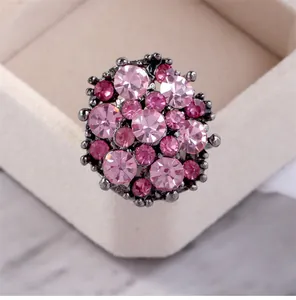 Vintage style cocktail ring featuring a cluster of pink crystals in dark metal finish