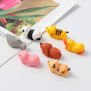 Detailed view of various cute cartoon animal cable protectors for phone chargers.