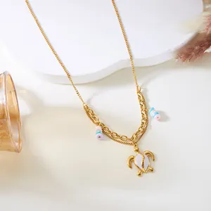 Vista detallada del collar bohemio de acero dorado con colgante de tortuga y cuentas.