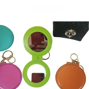 Detail of portable folding makeup mirrors with keychain in multiple vibrant colors
