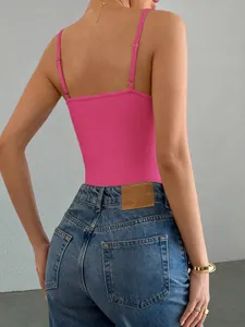 Close-up back view of a vibrant pink Y2K style spaghetti strap bodysuit with jeans