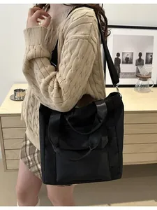 Large capacity black nylon tote bag for women with dual handles and shoulder strap