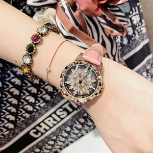 Detail of a pink leather watch with a diamond flower dial and gold bracelets