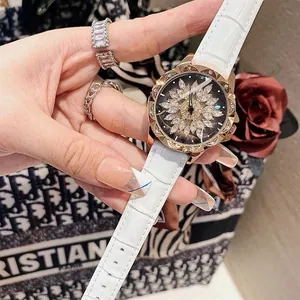 Macro shot of rose gold ladies watch with crystal flower dial and white leather strap