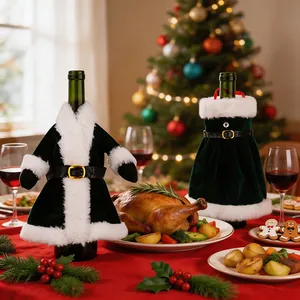 Festive Christmas wine bottle covers in dark green velvet suit and dress designs on table