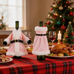 Close-up of pink plush Christmas dress and coat wine bottle covers on festive table