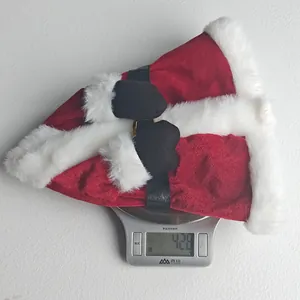 A detailed view showing the Santa suit Christmas wine bottle cover being weighed