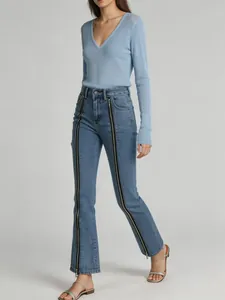 Full body view of stylish flared denim jeans featuring unique front zipper details