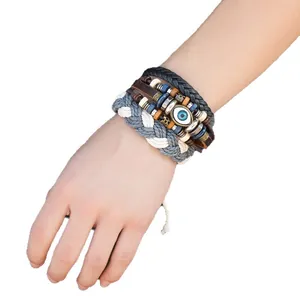 Men's multi-strand braided leather bracelet with evil eye beads and woven rope detail.