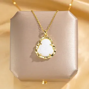 Detailed macro view of a white faux jade Buddha pendant with elegant golden frame
