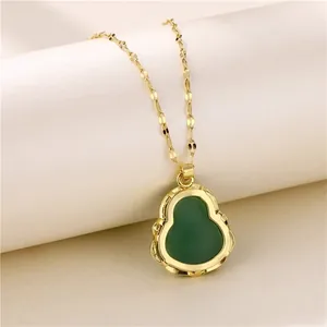 Detail view of golden titanium steel necklace with green jade-like Buddha pendant accessory