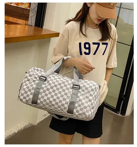 Large capacity checkerboard travel duffel bag for sports and short trips shown on model