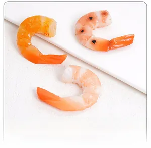 Detailed view of hyper-realistic PVC shrimp models showing cooked texture and handheld size