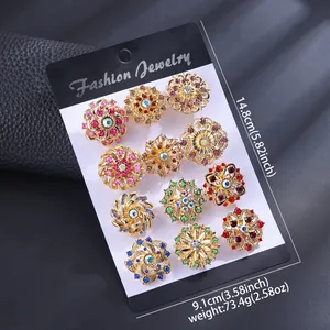 Macro view of 12-piece crystal flower brooches on a black display card and weight info