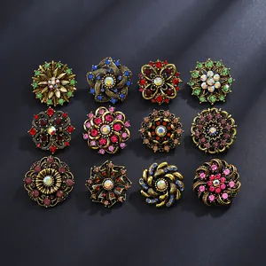 Detailed close-up of 12 vintage floral alloy brooches with colorful rhinestones set