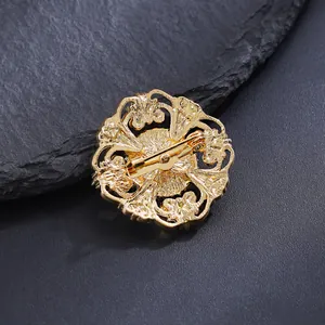 Exquisite gold floral brooch with intricate hollow patterns and secure pin clasp closure