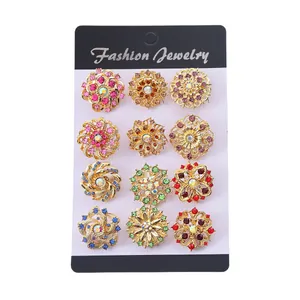Set of 12 luxury gold floral brooches with colorful rhinestones on a display card