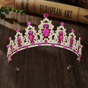 Detailed close-up of rose red crystals and rhinestones set on a gold crown headband