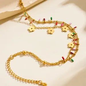 Double-layered golden necklace with colorful enamel flowers and adjustable lobster clasp