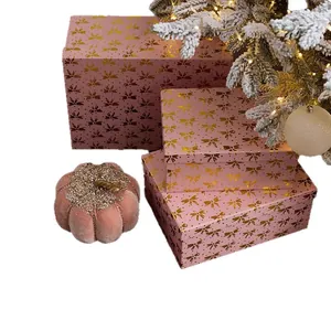 Set of pink festive gift boxes with gold bow pattern and velvet pumpkin