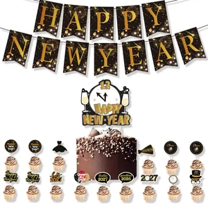Detail view of 2027 New Year party decorations including banner and cake toppers