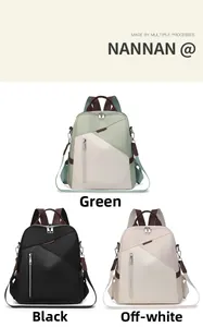 Detailed view of lightweight nylon backpacks in green, black and off-white colors