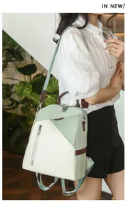 Detail showing the green and cream patchwork backpack with leather handles and silver hardware