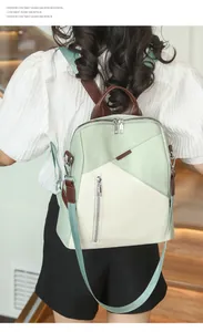 Rear view of model wearing a two-tone light green and beige nylon backpack